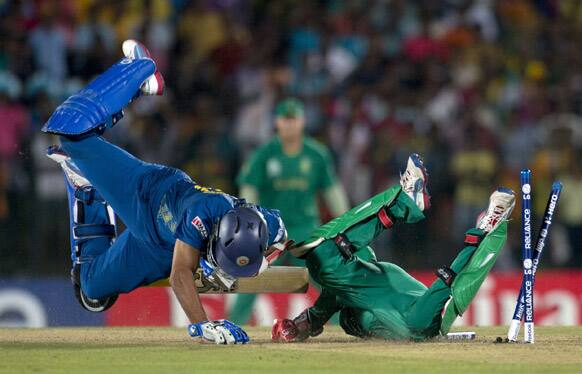 South Africa's captain AB de Villiers, right, lies on the ground after removing bails to runout Sri Lanka's batsman Tillakaratne Dilshan, left, during a ICC Twenty20 Cricket World Cup match between Sri Lanka and South Africa in Hambantota.