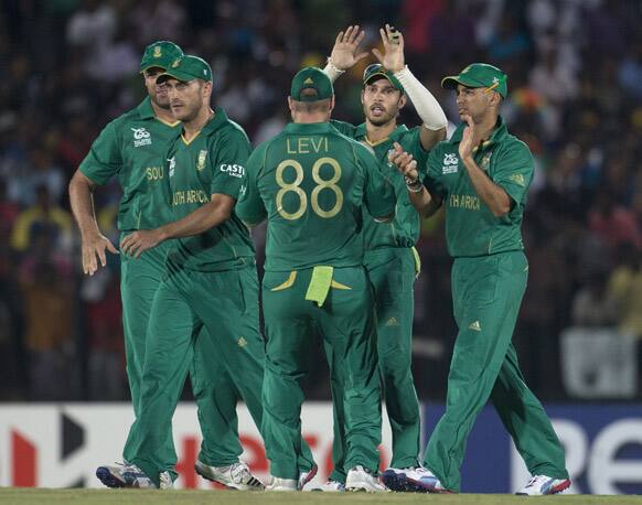 South Africa's Farhaan Behardien, second right celebrates with teammates after holding a catch to dismiss Sri Lanka's captain Mahela Jayawardena, unseen during a ICC Twenty20 Cricket World Cup match between Sri Lanka and South Africa in Hambantota, Sri Lanka.