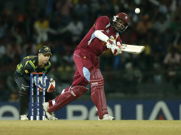 West Indies' batsman Chris Gayle plays a shot as Australia's wicket keeper Matthew Wade watches during their ICC Twenty20 Cricket World Cup match in Colombo, Sri Lanka.