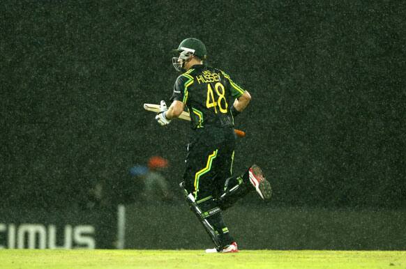 Australia's batsman Michael Hussey runs towards the pavilion as it rains during their ICC Twenty20 Cricket World Cup match against West Indies' in Colombo.