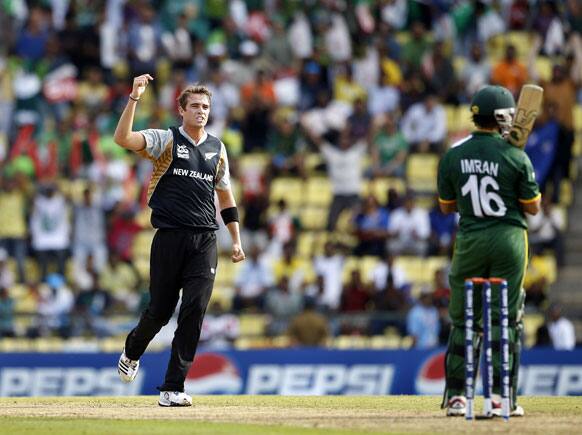 New Zealand's bowler Tim Southee, left, celebrates after taking the wicket of Pakistan's batsman Imran Nazir, right, during their ICC Twenty20 Cricket World Cup match in Pallekele.