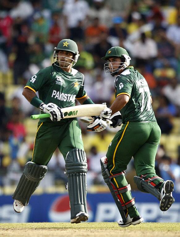 Pakistan's captain Mohammad Hafeez, left, and teammate Nasir Jamshed run between the wickets to add runs during their ICC Twenty20 Cricket World Cup match against New Zealand in Pallekele.