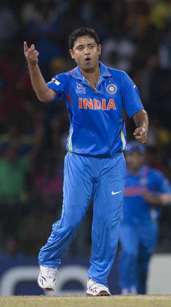 India's bowler Piyush Chawla celebrates the dismissal of England's Jonny Bairstow, unseen, during a ICC Twenty20 Cricket World Cup match between England and India in Colombo.