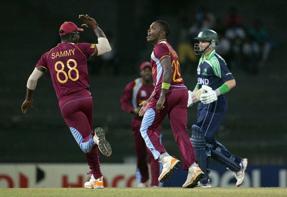 West Indies' bowler Fidel Edwards, center celebrates the dismissal of Ireland's captain William Porterfield, right during the ICC Twenty20 Cricket World Cup match between Ireland and West Indies, in Colombo.