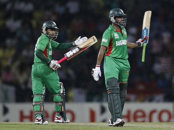 Bangladesh captain Mushfiqur Rahim, left, applauds teammate Shakib Al Hasan, right, on scoring a half century during the ICC Twenty20 Cricket World Cup match against Pakistan in Pallekele, Sri Lanka.