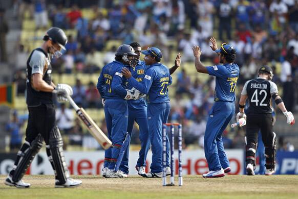 Sri Lanka's bowler Ajantha Mendis celebrates with teammates the dismissal of New Zealand's batsman Brendon McCullum during the ICC Twenty20 Cricket World Cup Super Eight match in Pallekele.