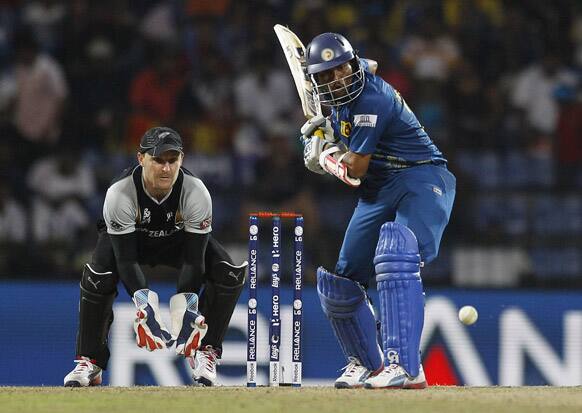 New Zealand's wicketkeeper Brendon McCullum, left, watches Sri Lanka's batsman Tillakaratne Dilshan play a shot during the ICC Twenty20 Cricket World Cup Super Eight match in Pallekele, Sri Lanka.