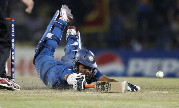 Sri Lanka's batsman Lahiru Thirimanne dives unsuccessfully to make it to the crease to avoid his run-out on the last ball of the ICC Twenty20 Cricket World Cup Super Eight match against New Zealand in Pallekele, Sri Lanka.