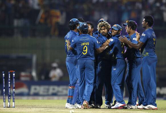 Sri Lanka's bowler Lasith Malinga, center without cap, celebrates with teammates their win over New Zealand in the super over of the ICC Twenty20 Cricket World Cup Super Eight match in Pallekele.