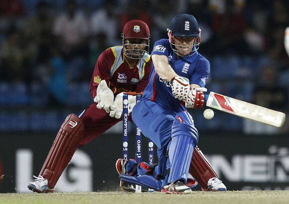 England's batsman Eoin Morgan, right, plays a shot during the ICC Twenty20 Cricket World Cup Super Eight match against West Indies' in Pallekele, Sri Lanka.