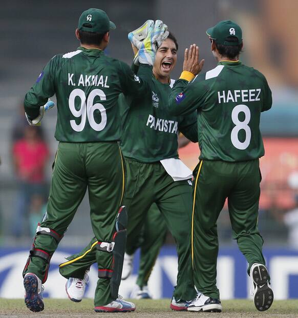 Pakistan's bowler Saeed Ajmal, center, celebrates with teammates the dismissal of South Africa's batsmen Richard Levi, unseen, during their ICC Twenty20 Cricket World Cup Super Eight match in Colombo.