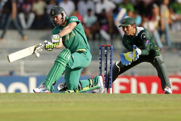 South Africa's captain A.B. de Villiers ,left, plays a shot in front of Pakistan's wicketkeeper Kamran Akmal during their ICC Twenty20 Cricket World Cup Super Eight match in Colombo.