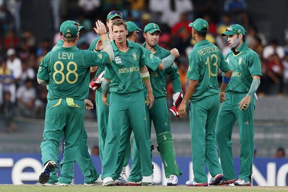 South African bowler Dale Steyn, second left, facing the camera, celebrates the dismissal of Pakistan's batsman Imran Nazir, unseen, with teammates during their ICC Twenty20 Cricket World Cup Super Eight match in Colombo.