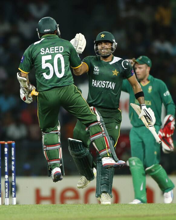 Umar Akmal and Saeed Ajaml celebrate their team's two wicket win over South Africa during their ICC Twenty20 Cricket World Cup Super Eight match in Colombo.