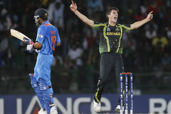 Australia's bowler Pat Cummins, right, celebrates the dismissal of India's batsman Virat Kohli, left, during a ICC Twenty20 Cricket World Cup Super Eight match between India and Australia in Colombo.