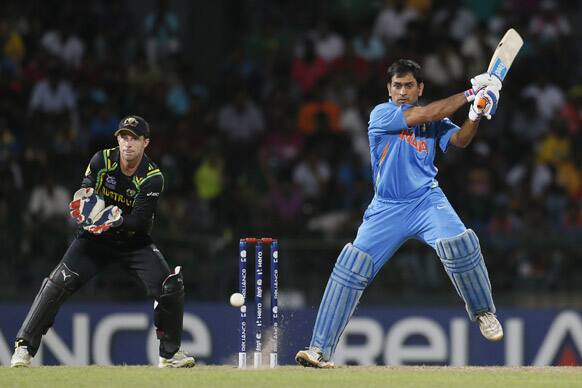 India's captain Mahendra Singh Dhoni, right, bats as Australia's wicket keeper Matthew Wade watches during a ICC Twenty20 Cricket World Cup Super Eight match between India and Australia in Colombo.