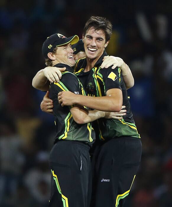 Australia's bowler Pat Cummins, celebrates the dismissal of India's batsman Mahendra Singh Dhoni, unseen, with captain George Bailey during the ICC Twenty20 Cricket World Cup Super Eight match in Colombo.