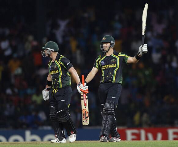 Australia's batsman Shane Watson, right, acknowledges scoring a half century as non striker David Warner watches during the ICC Twenty20 Cricket World Cup Super Eight match in Colombo.