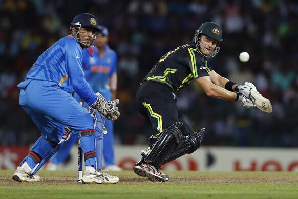 Australia's batsman Shane Watson plays a shot against India as Mahendra Singh Dhoni, left, watches during the ICC Twenty20 Cricket World Cup Super Eight match in Colombo.