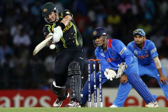 Australia's batsman Shane Watson plays a shot against India as Mahendra Singh Dhoni, left, watches during the ICC Twenty20 Cricket World Cup Super Eight match in Colombo.