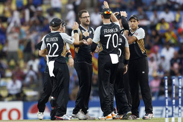 New Zealand's bowler Daniel Vettori, center without cap, celebrates with teammates the dismissal of England's batsman Craig Kieswetter, not seen, during their ICC Twenty20 Cricket World Cup Super Eight match in Pallekele.