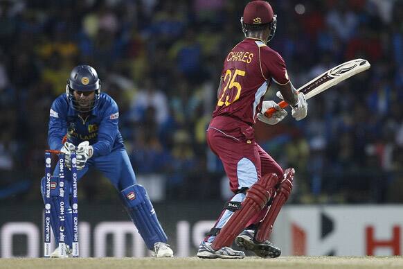 Sri Lanka's wicketkeeper Kumar Sangakkara, left, takes off the bails to stump out West Indies' batsman Johnson Charles, right, during the ICC Twenty20 Cricket World Cup Super Eight match in Pallekele.