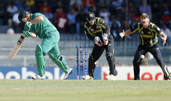 South Africa's batsman Richard Levi, left, is bowled out by Australia's bowler Xavier Doherty, unseen, as wicketkeeper, Matthew Wade, center, and fielder Cameron White watch during the ICC Twenty20 Cricket World Cup Super Eight match between Australia and South Africa in Colombo.