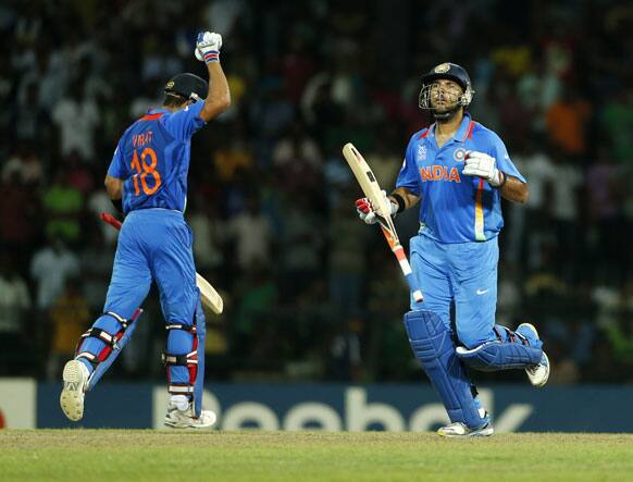 India's batsmen Virat Kohli, left, and Yuvraj Singh celebrate the victory over Pakistan by 8 wickets in the ICC Twenty20 Cricket World Cup Super Eight match between India and Pakistan in Colombo.