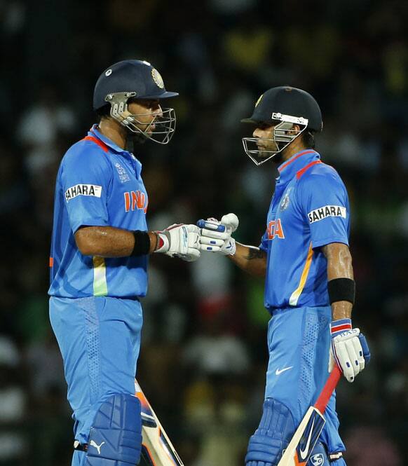 India's batsmen Virat Kohli, right, and Yuvraj Singh celebrate the victory over Pakistan by 8 wickets in the ICC Twenty20 Cricket World Cup Super Eight match between India and Pakistan in Colombo.