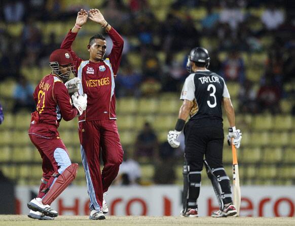 West Indies' bowler Sunil Narine, center, celebrates the dismissal of New Zealand's batsman James Franklin, not seen, during their ICC Twenty20 Cricket World Cup Super Eight match in Pallekele.