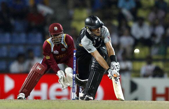 New Zealand's captain Ross Taylor, right, plays a shot during Super Over of the ICC Twenty20 Cricket World Cup Super Eight match against West Indies in Pallekele, Sri Lanka.