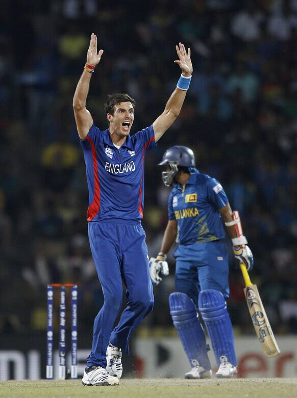 England's bowler Steven Finn, left, celebrates the dismissal of Sri Lanka's batsman Tillakaratne Dilshan, right, during the ICC Twenty20 Cricket World Cup Super Eight match in Pallekele.