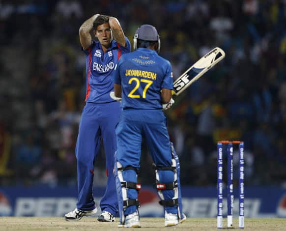 England's bowler Jade Dernbach, left, reacts after he misses a chance to dismiss Sri Lanka's captain Mahela Jayawardene, right, during the ICC Twenty20 Cricket World Cup Super Eight match in Pallekele.