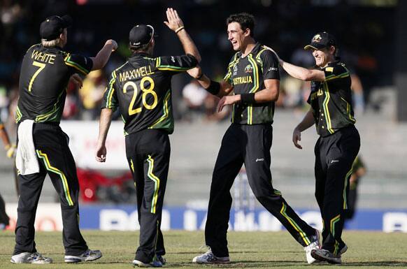 Australia's bowler Xavier Doherty, second right, celebrates the dismissal of Pakistan's batsman Nasir Jamshed, unseen, with captain George Bailey, right, and other teammates during their ICC Twenty20 Cricket World Cup Super Eight match in Colombo.