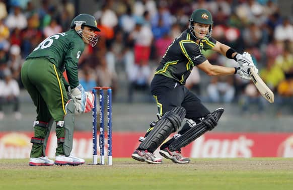 Pakistan's wicketkeeper Kamran Akmal, left, watches Australia's batsman Shane Watson play a shot during their ICC Twenty20 Cricket World Cup Super Eight match in Colombo.