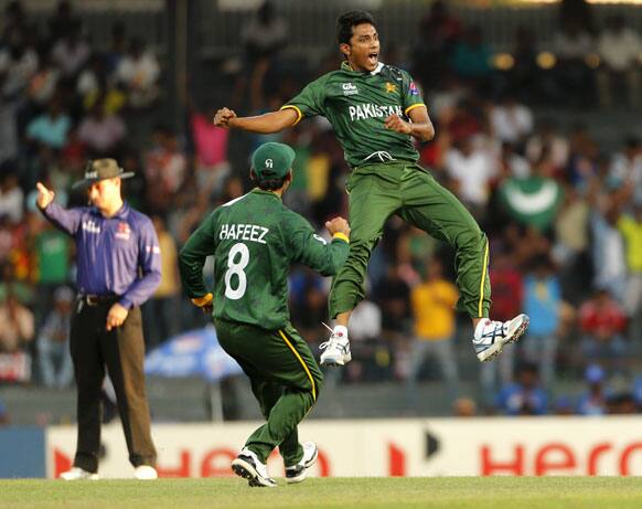 Pakistan's bowler Raza Hasan, right, celebrates taking the wicket of Australia's batsman Shane Watson, unseen, with Pakistan's captain Mohammad Hafeez (8) during their ICC Twenty20 Cricket World Cup Super Eight match in Colombo, Sri Lanka.