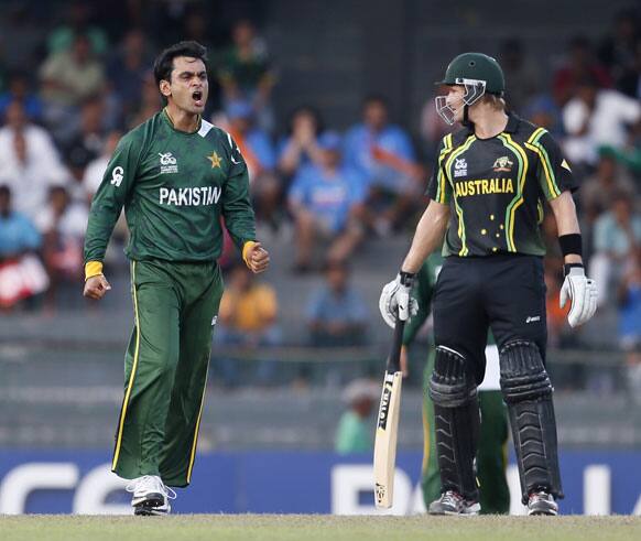 Mohammad Hafeez, left, reacts after an appeal for a leg before the wickets decision against Australia's batsman David Warner, unseen, was turned down as Australian non striker Shane Watson, right, watches Hafeez during their ICC Twenty20 Cricket World Cup Super Eight match in Colombo.