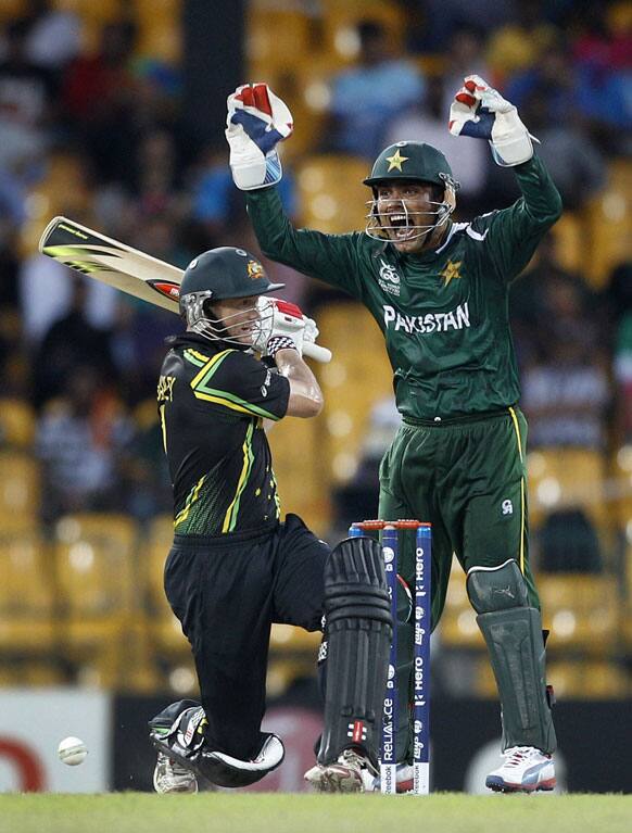 Pakistan's wicketkeeper Kamran Akmal, right, appeals for the wicket of Australia's captain George Bailey, left, during their ICC Twenty20 Cricket World Cup Super Eight match in Colombo.