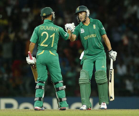 South Africa's batsmen Jean-Paul Duminy, left, and Faf du Plessis cheer each other during the ICC Twenty20 Cricket World Cup Super Eight match between India and South Africa in Colombo.