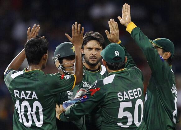 Pakistan's bowler Shahid Afridi, center, celebrates with teammates the dismissal of Sri Lanka's captain Mahela Jayawardene, not seen, during the ICC Twenty20 Cricket World Cup semifinal match in Colombo.