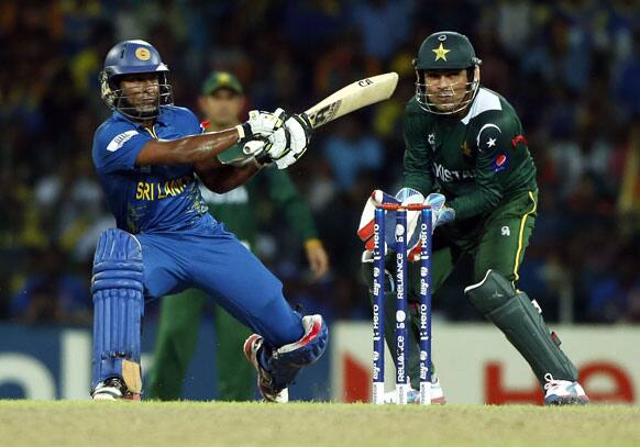 Sri Lanka's Jeevan Mendis, left, plays a shot as Pakistan's wicketkeeper Kamran Akmal watches during the ICC Twenty20 Cricket World Cup semi final match between Pakistan and Sri Lanka in Colombo.