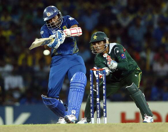 Sri Lanka's Tillakaratne Dilshan, left, plays a shot as Pakistan's wicketkeeper Kamran Akmal watches during the ICC Twenty20 Cricket World Cup semi final match between Pakistan and Sri Lanka in Colombo.