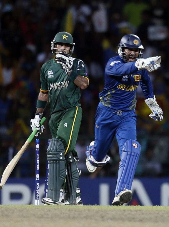 Sri Lanka's Kumar Sangakkara, right celebrates the dismissal of Pakistan's captain Mohammad Hafeez, left during the ICC Twenty20 Cricket World Cup semifinal match between Sri Lanka and Pakistan in Colombo.