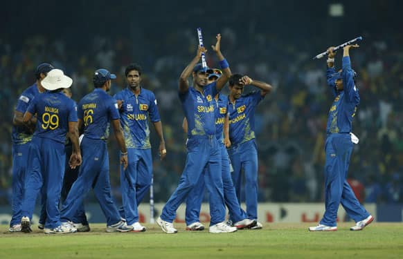 Members of the Sri Lankan team celebrate their victory over Pakistan by 16 runs in the ICC Twenty20 Cricket World Cup semi final match between Pakistan and Sri Lanka in Colombo.