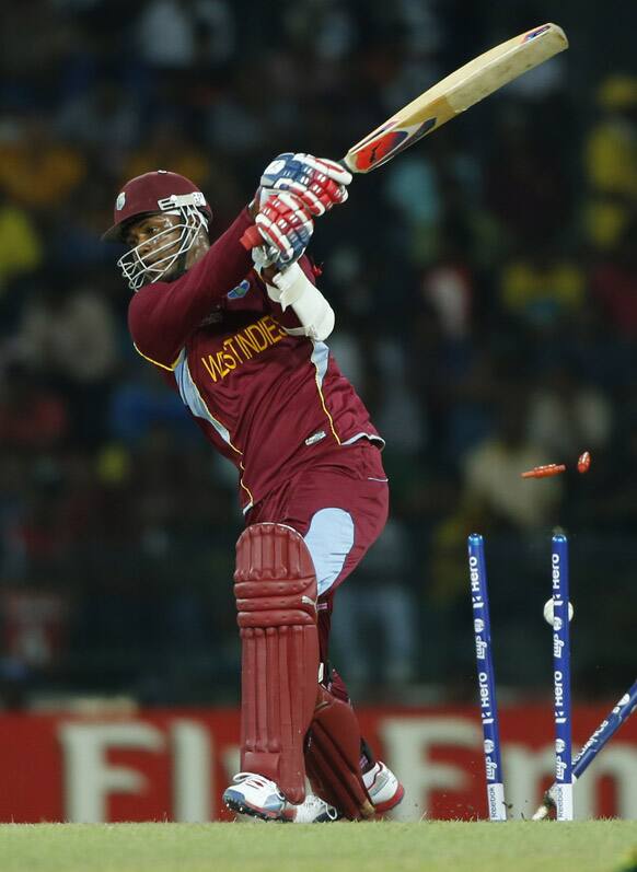 West Indies' batsman Marlon Samuels bowled out by Australia's Pat Cummins, unseen, during the ICC Twenty20 Cricket World Cup semi final match between Australia and West Indies' in Colombo.