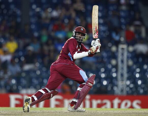 West Indies' batsman Chris Gayle watches his shot during the ICC Twenty20 Cricket World Cup semifinal match against Australia in Colombo.