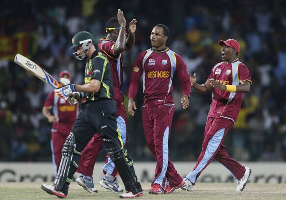 West Indies's bowler Marlon Samuels, second right celebrates the dismissal of Australia's batsman Michael Hussey, left, during the ICC Twenty20 Cricket World Cup semifinal match between Australia and West Indies in Colombo.