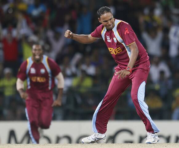 West Indies's bowler Samuel Badree celebrates the dismissal of Australia's batsman Shane Watson, unseen during the ICC Twenty20 Cricket World Cup semifinal match between Australia and West Indies in Colombo.