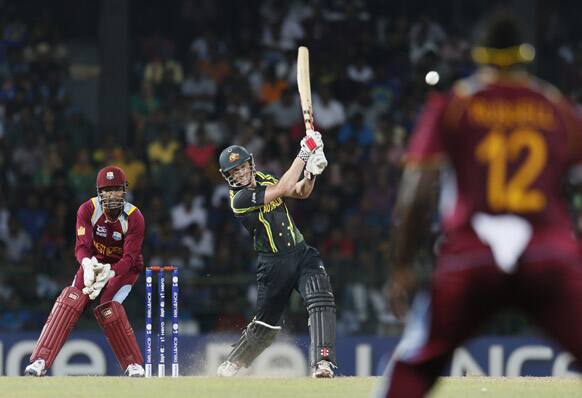 Australia's captain George Bailey, center bats as West Indies's wicket keeper Denesh Ramdin, right watches during the ICC Twenty20 Cricket World Cup semifinal match between Australia and West Indies in Colombo.