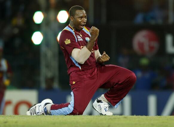 West Indies' bowler Kieron Pollard celebrates taking the wicket of Australia captain George Bailey, unseen,during the ICC Twenty20 Cricket World Cup semi final match between Australia and West Indies' in Colombo.